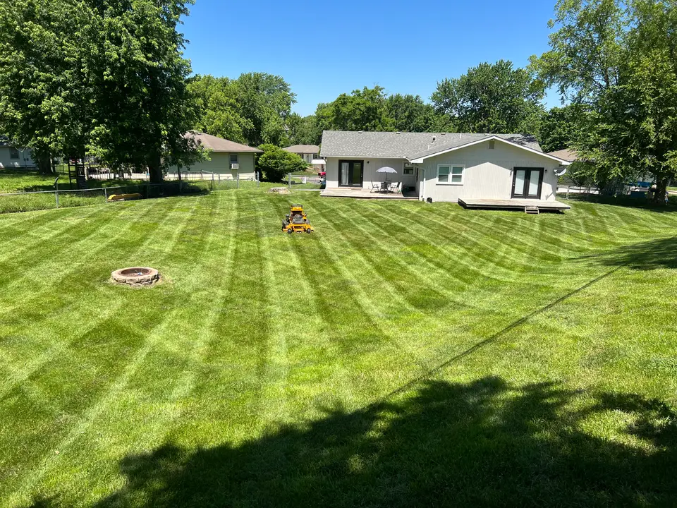 Freshly striped lawn in front of a ranch-style home