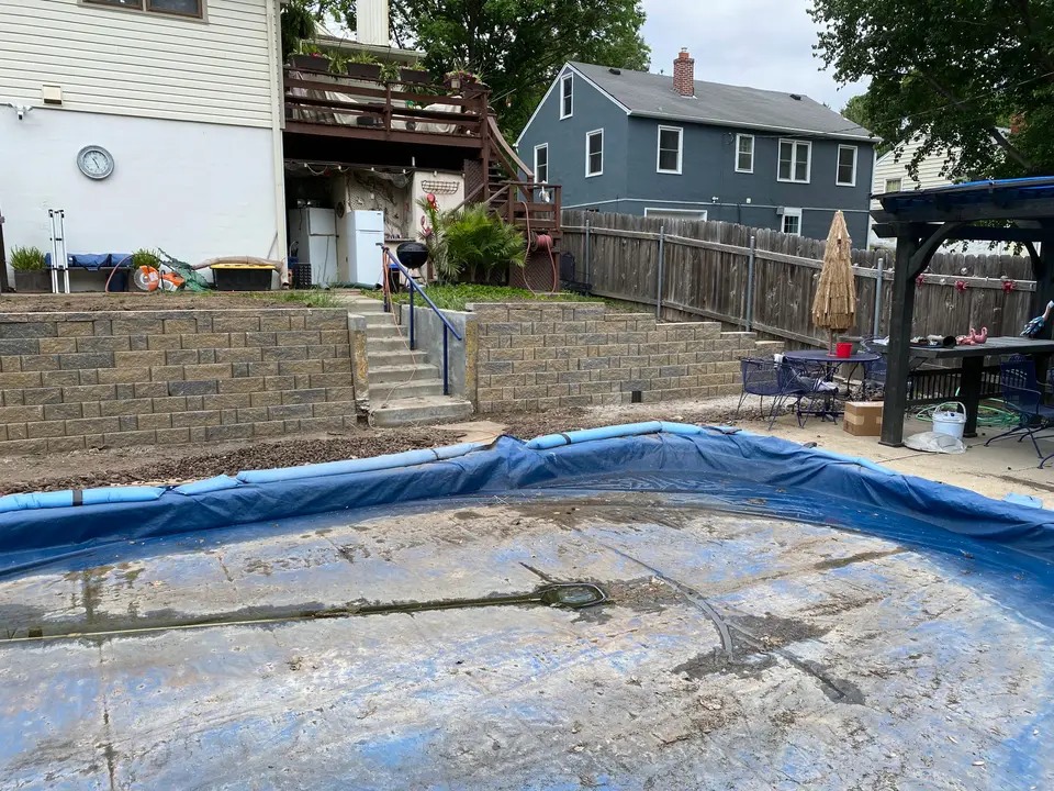 Block retaining walls and steps around a backyard pool