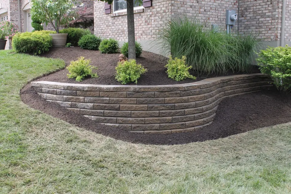 Stone retaining wall and planting bed with fresh mulch